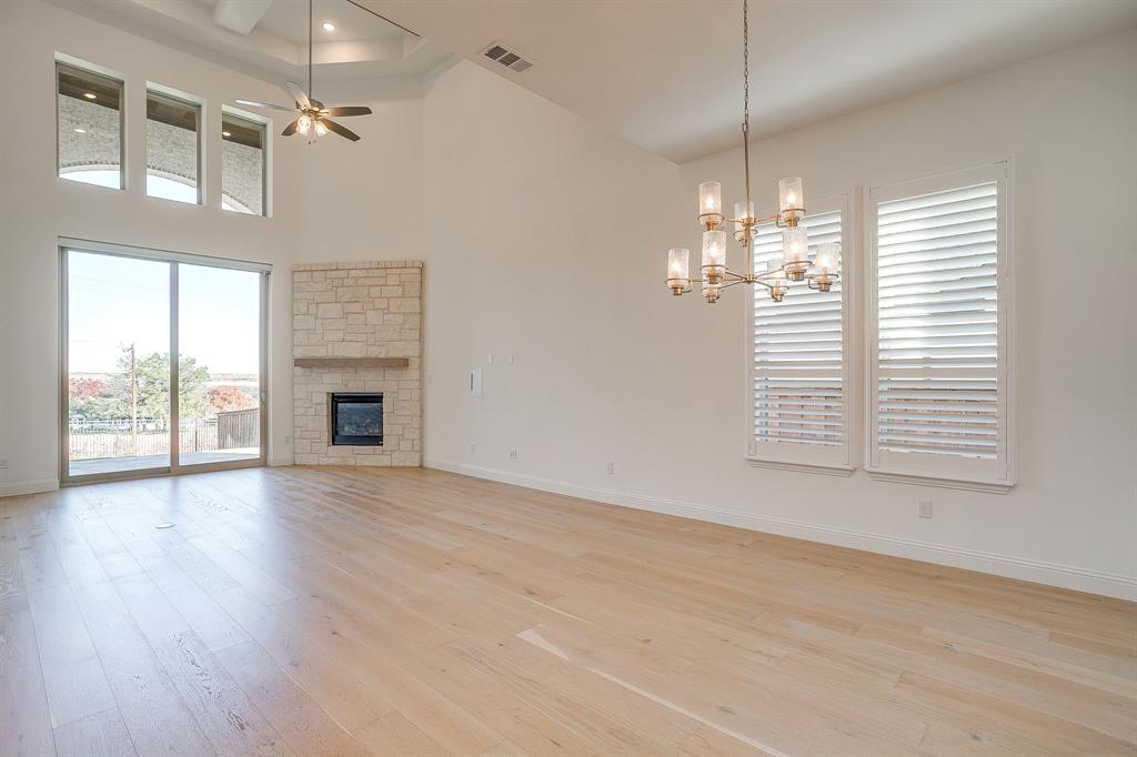 14328 Capridge Road Fort Worth, TX 76008 - Photo 5 of 39 an empty room with wooden floor chandelier and windows
