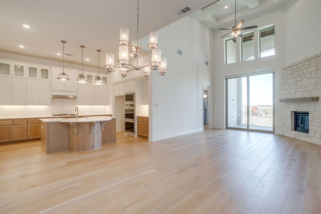 14328 Capridge Road Fort Worth, TX 76008 - Photo 7 of 39 a large kitchen with cabinets and wooden floor