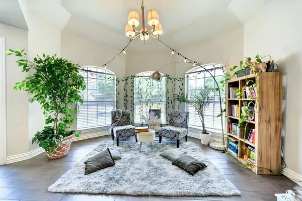 a living room with furniture lamp and rug