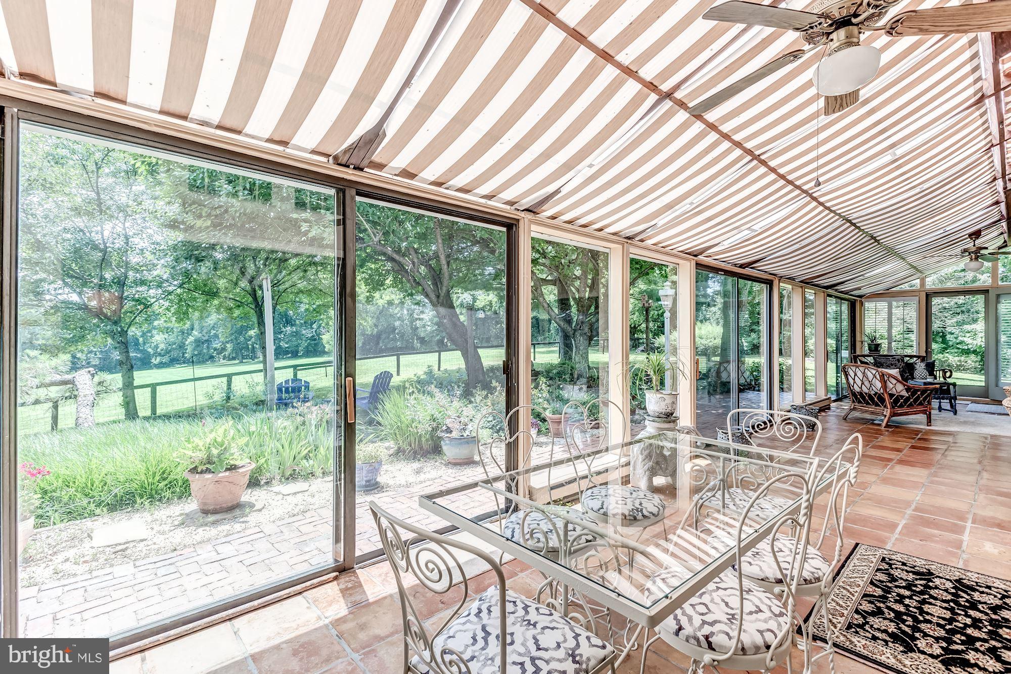 23009 Cobb House Road Middleburg, VA 20117 - Photo 22 of 50 Large glass doors/window leading to patio/gardens