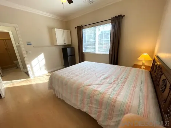 a bed sitting in a bedroom next to a window