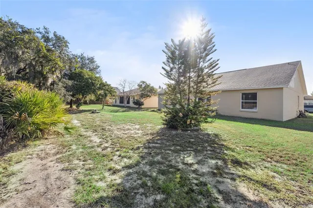 a view of a house with yard and tree s