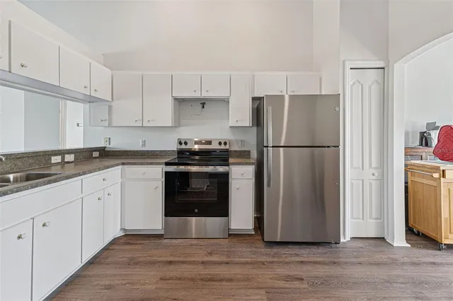 a kitchen with a refrigerator and a sink