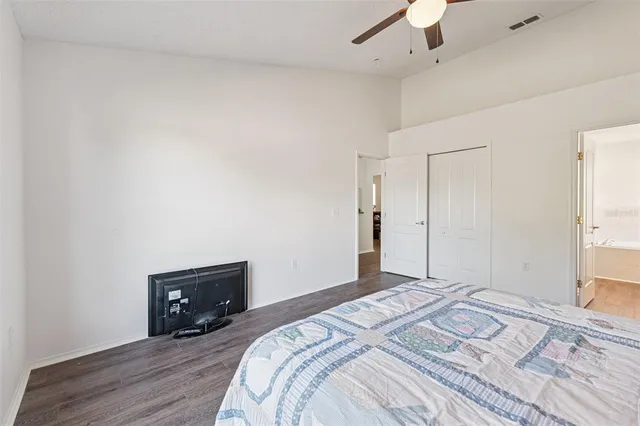 a bedroom with a bed and a tv