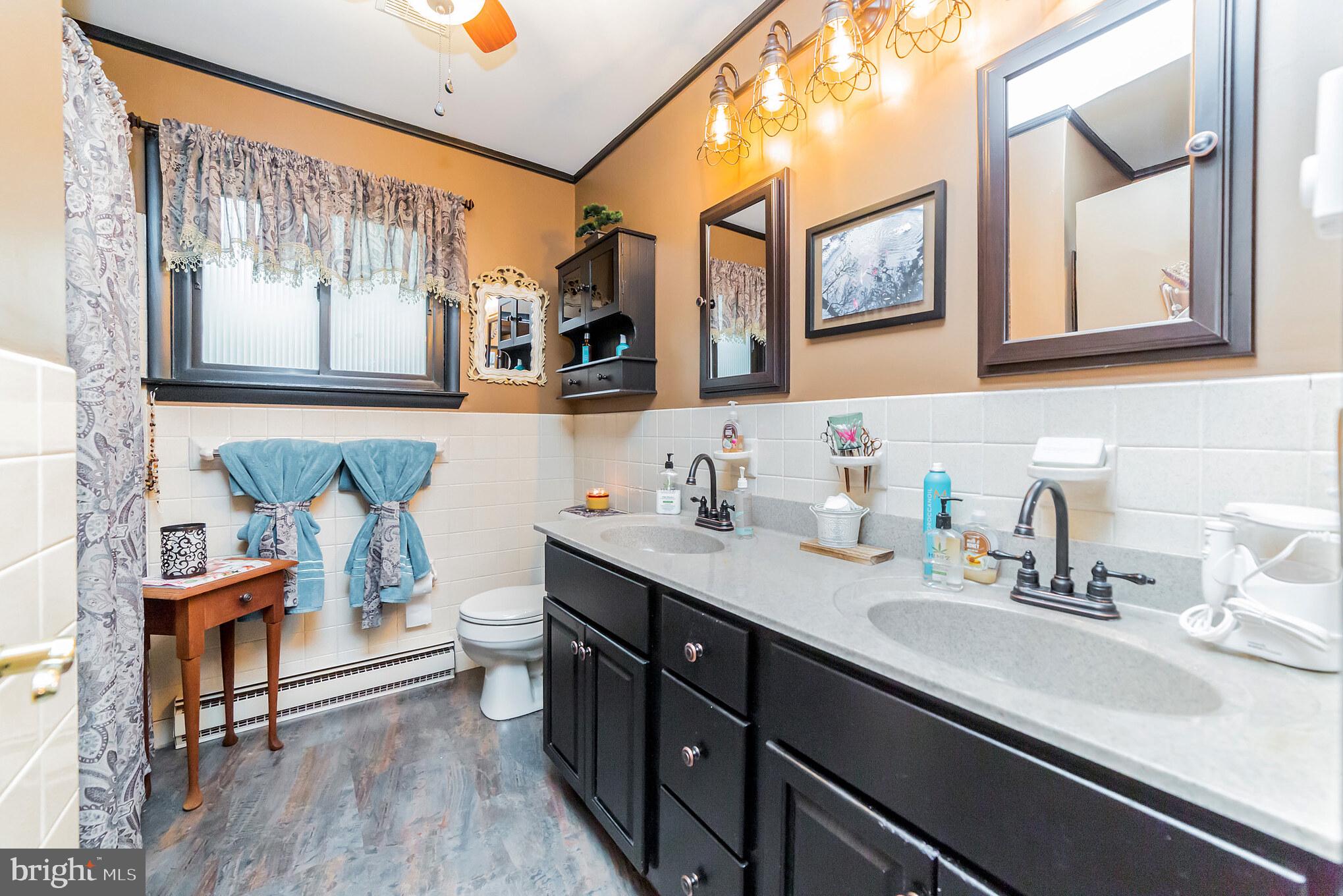 948 Callowhill Road Perkasie, PA 18944 - Photo 16 of 29 a bathroom with a double vanity sink and a mirror