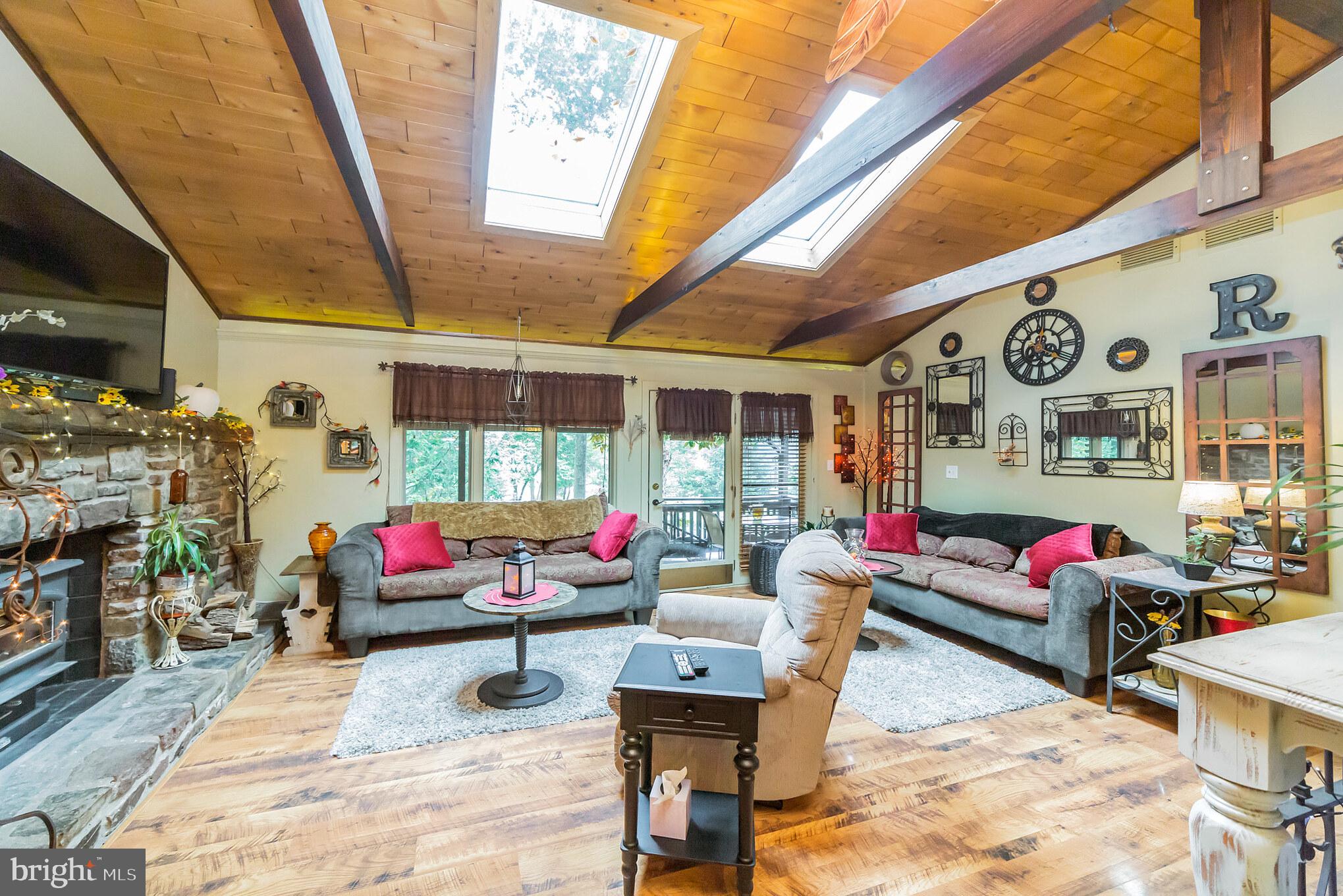 948 Callowhill Road Perkasie, PA 18944 - Photo 4 of 29 a living room filled with furniture and a floor to ceiling window