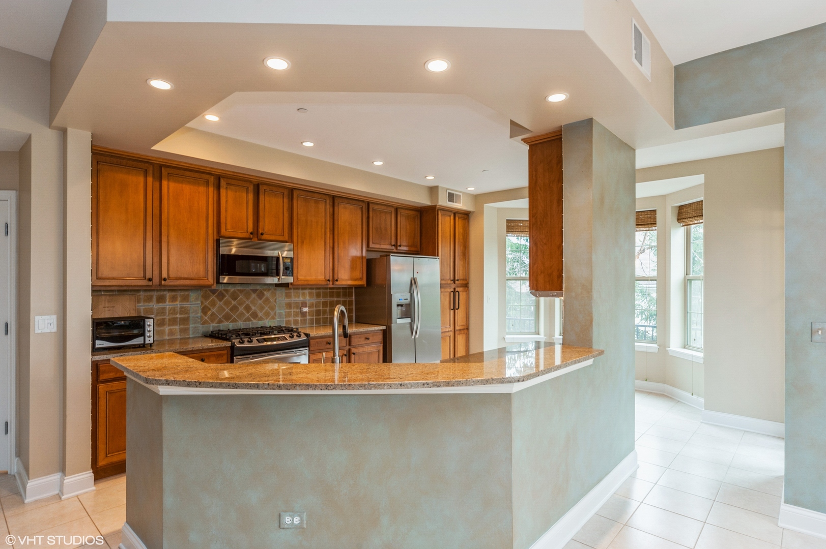 2700 Summit Drive, Unit 101 Glenview, IL 60025 - Photo 2 of 14 a kitchen with stainless steel appliances granite countertop a sink refrigerator and cabinets