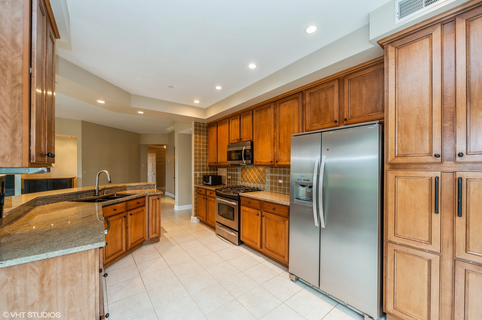 2700 Summit Drive, Unit 101 Glenview, IL 60025 - Photo 3 of 14 a kitchen with stainless steel appliances granite countertop a refrigerator a stove and a sink with wooden floor