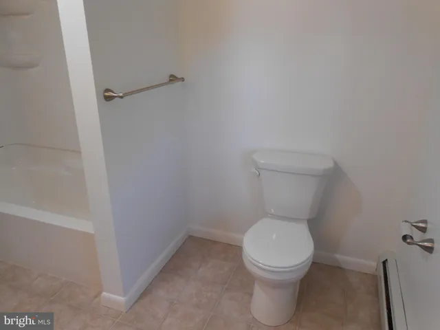 a white toilet sitting in a bathroom