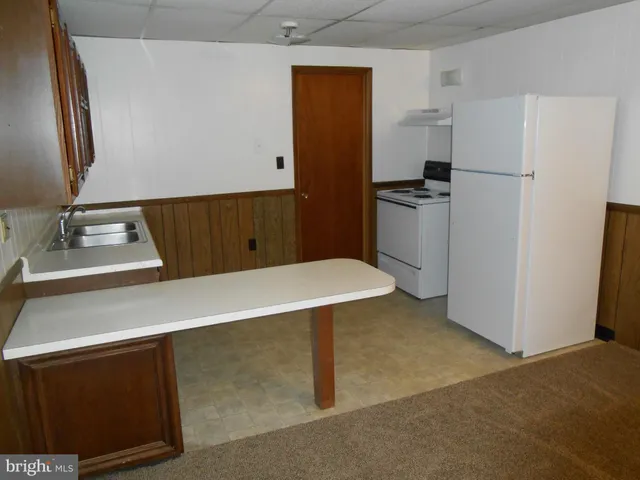 a kitchen with a refrigerator and a sink