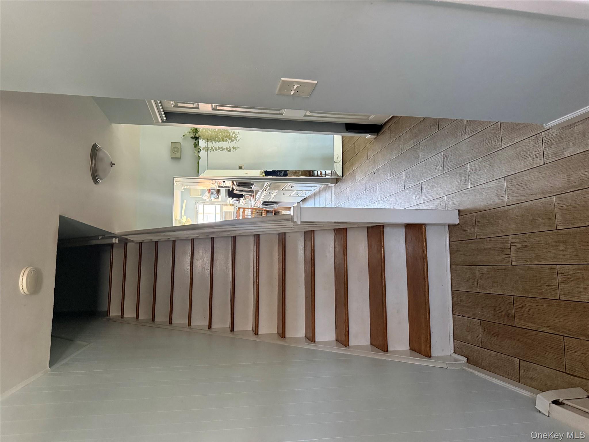 39 Coolidge Street Haverstraw, NY 10927 - Photo 3 of 13 a view of a hallway with wooden floor and stairs