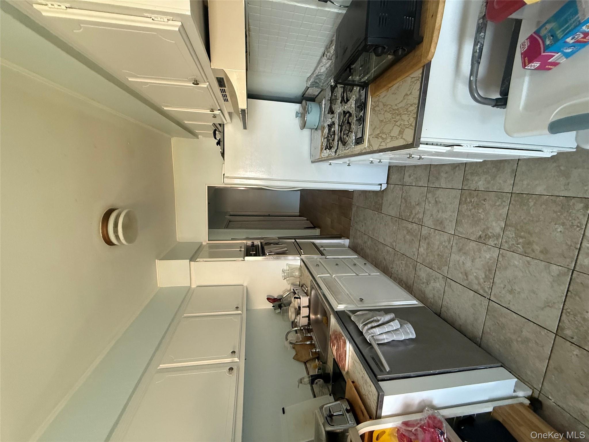 39 Coolidge Street Haverstraw, NY 10927 - Photo 5 of 13 a kitchen with a stove a sink and a refrigerator