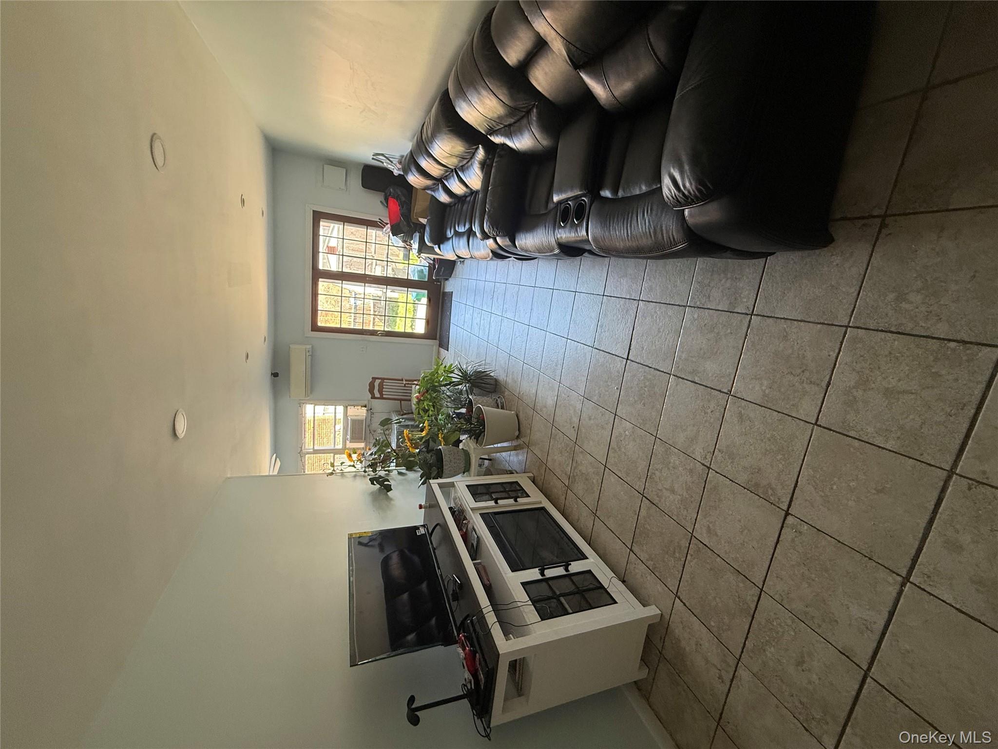 39 Coolidge Street Haverstraw, NY 10927 - Photo 6 of 13 a living room with furniture and a flat screen tv