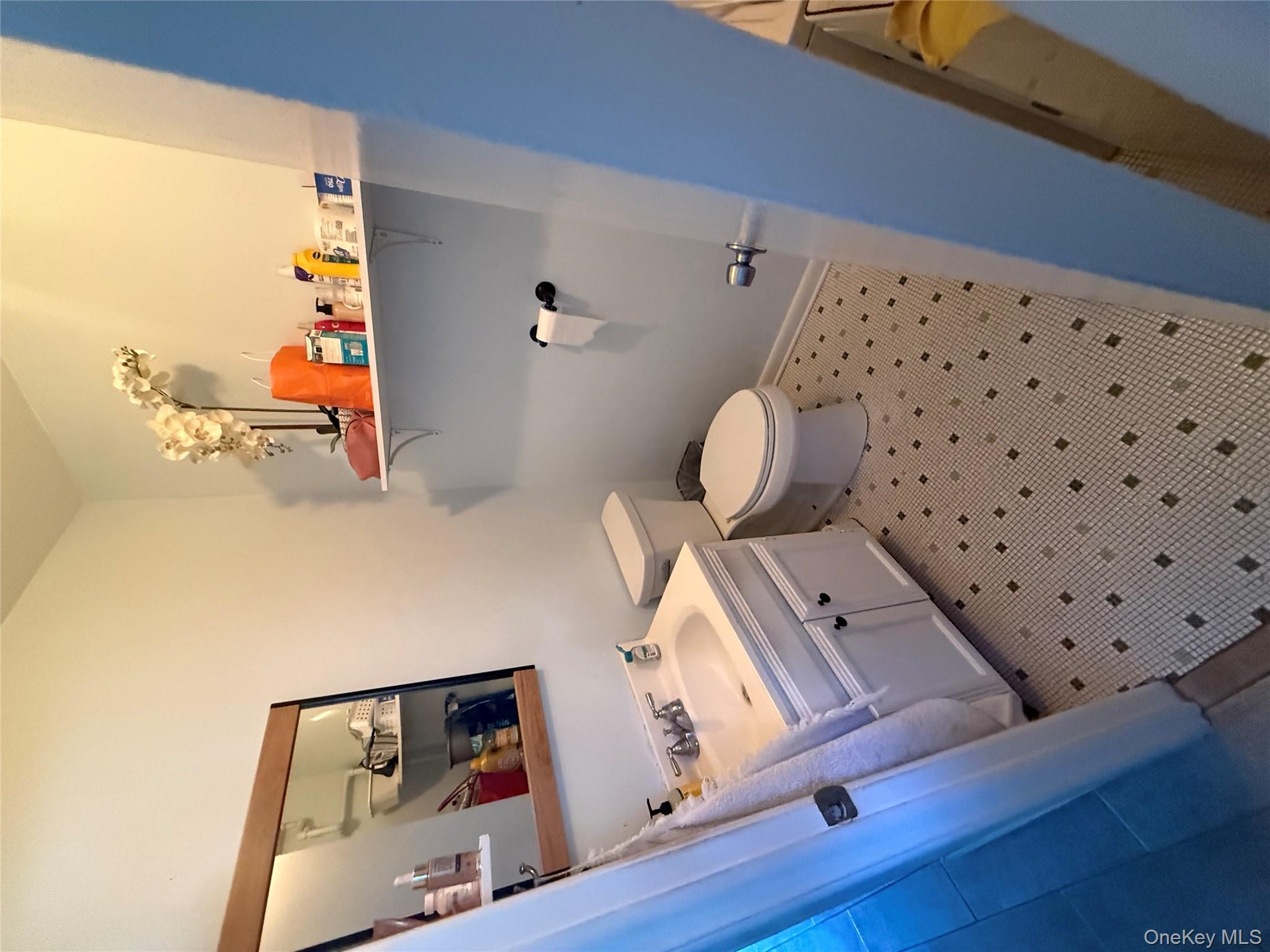 39 Coolidge Street Haverstraw, NY 10927 - Photo 7 of 13 a bathroom with a sink a toilet and a mirror