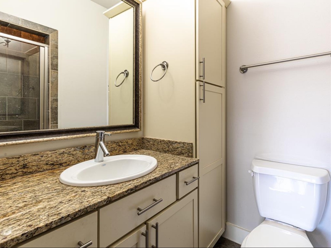 1441 Wagner Street Houston, TX 77007 - Photo 15 of 19 a bathroom with a granite countertop sink toilet and a mirror