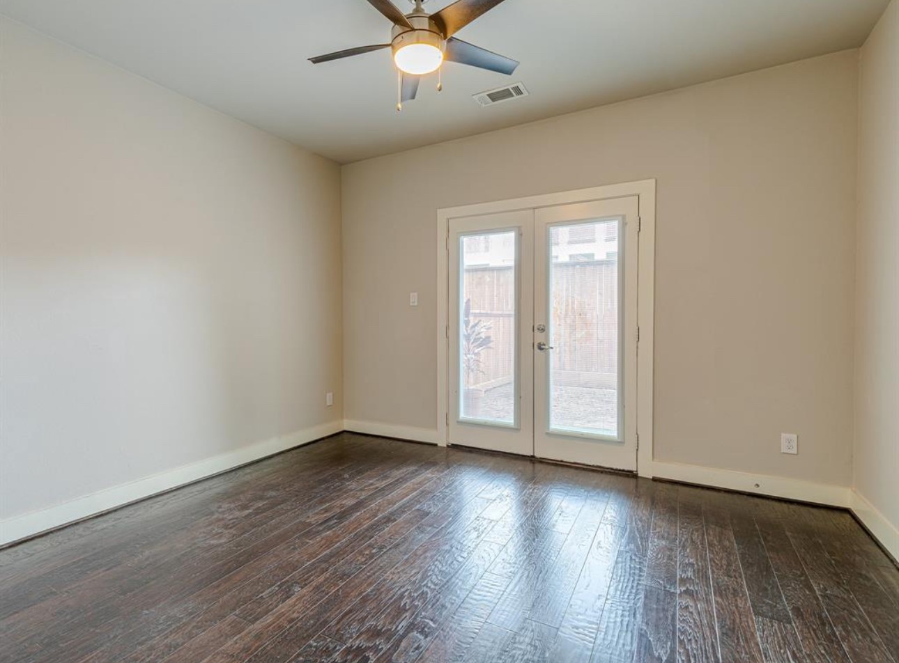 1441 Wagner Street Houston, TX 77007 - Photo 16 of 19 an empty room with wooden floor fan and windows