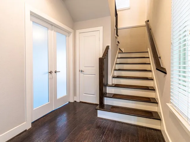 a view of a room with wooden floor and white walls