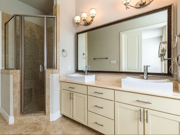 a bathroom with a double vanity sink and a mirror