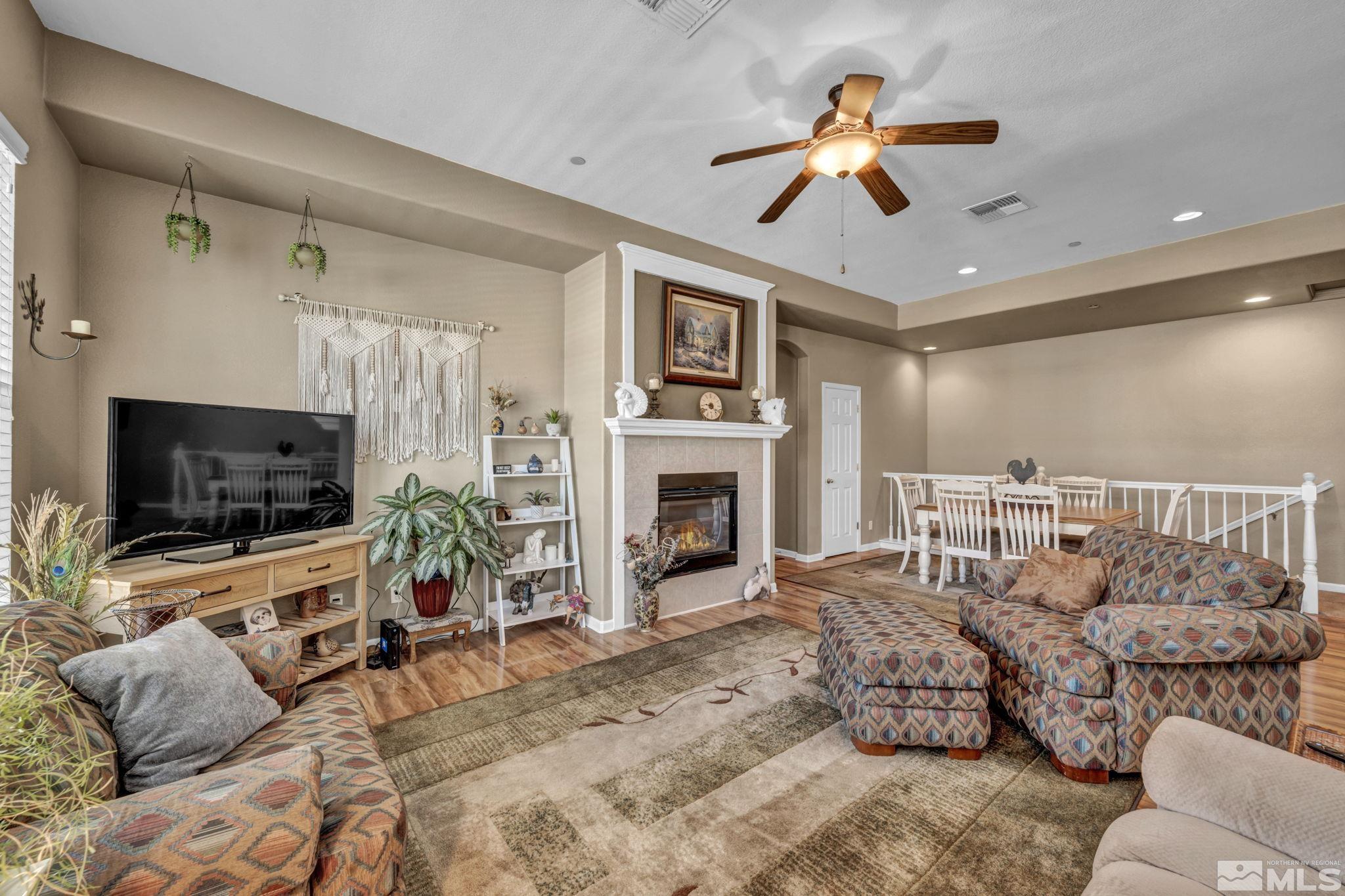 1924 Wind Ranch Road, Unit C Reno, NV 89521 - Photo 11 of 27 a living room with furniture a flat screen tv and a fireplace