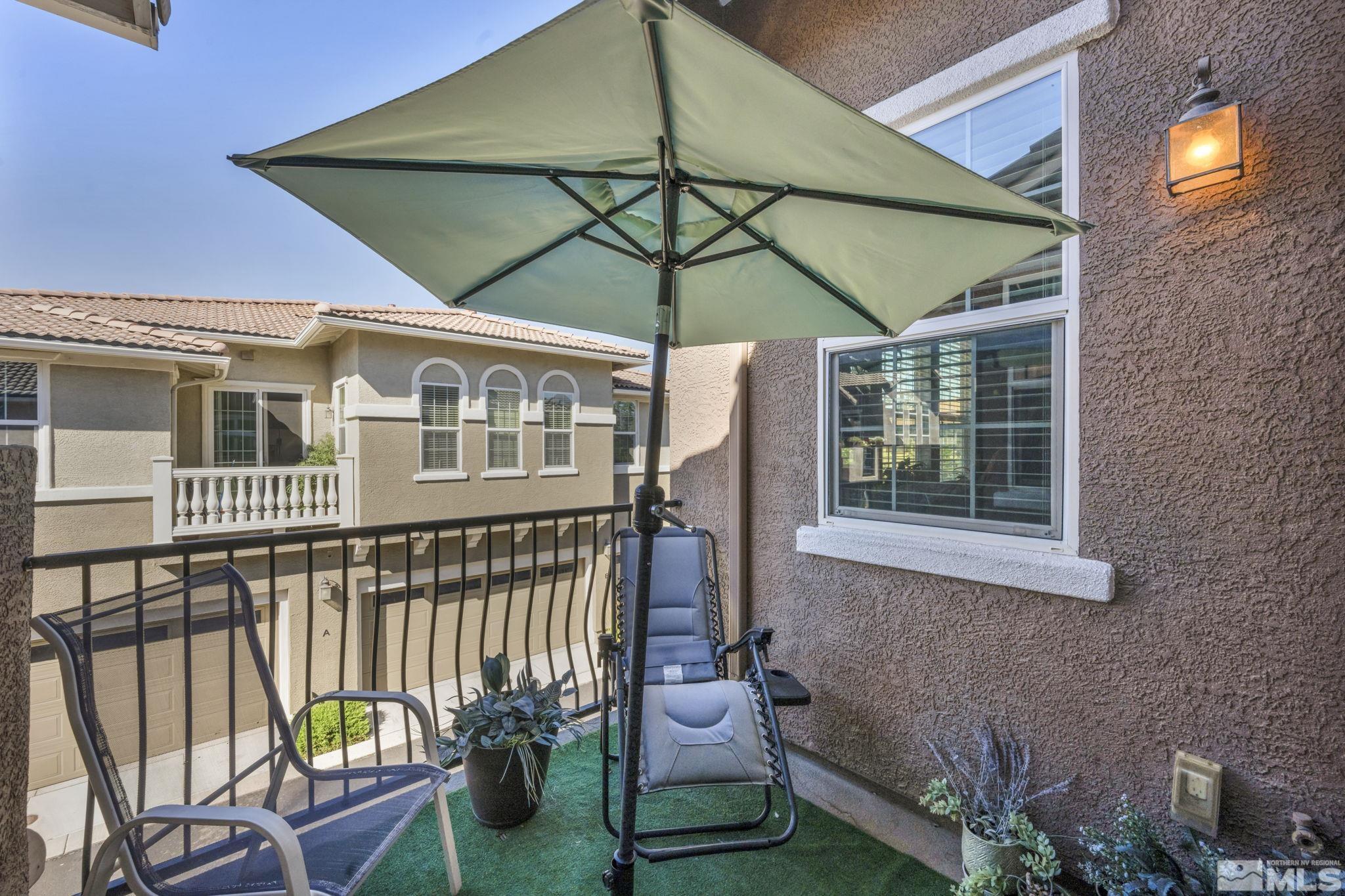 1924 Wind Ranch Road, Unit C Reno, NV 89521 - Photo 17 of 27 a balcony with table and chairs