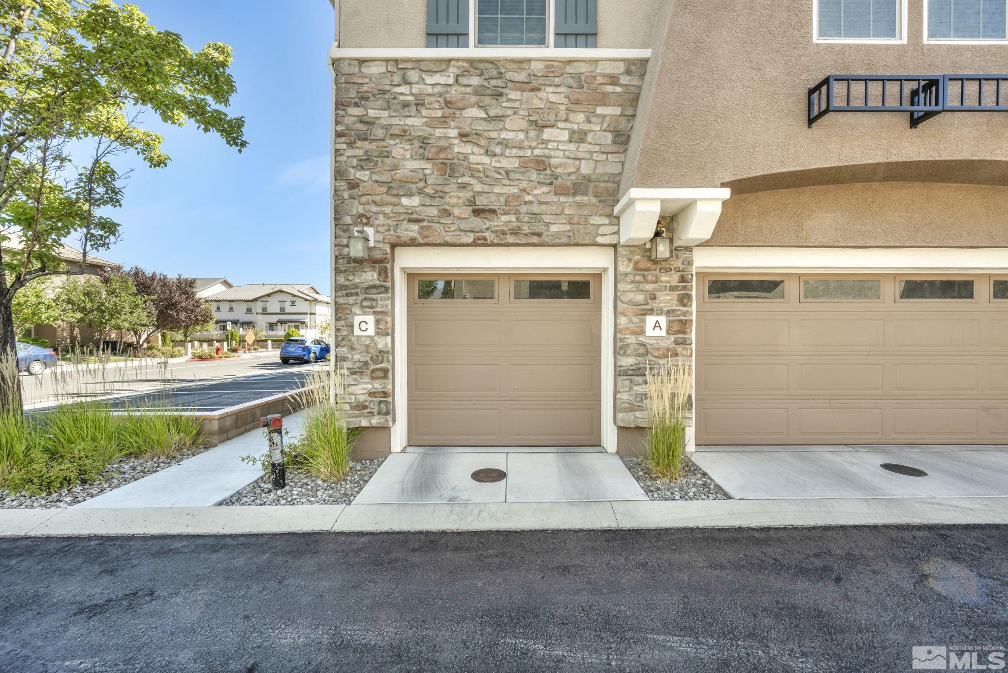 1924 Wind Ranch Road, Unit C Reno, NV 89521 - Photo 2 of 27 a front view of a house with a yard