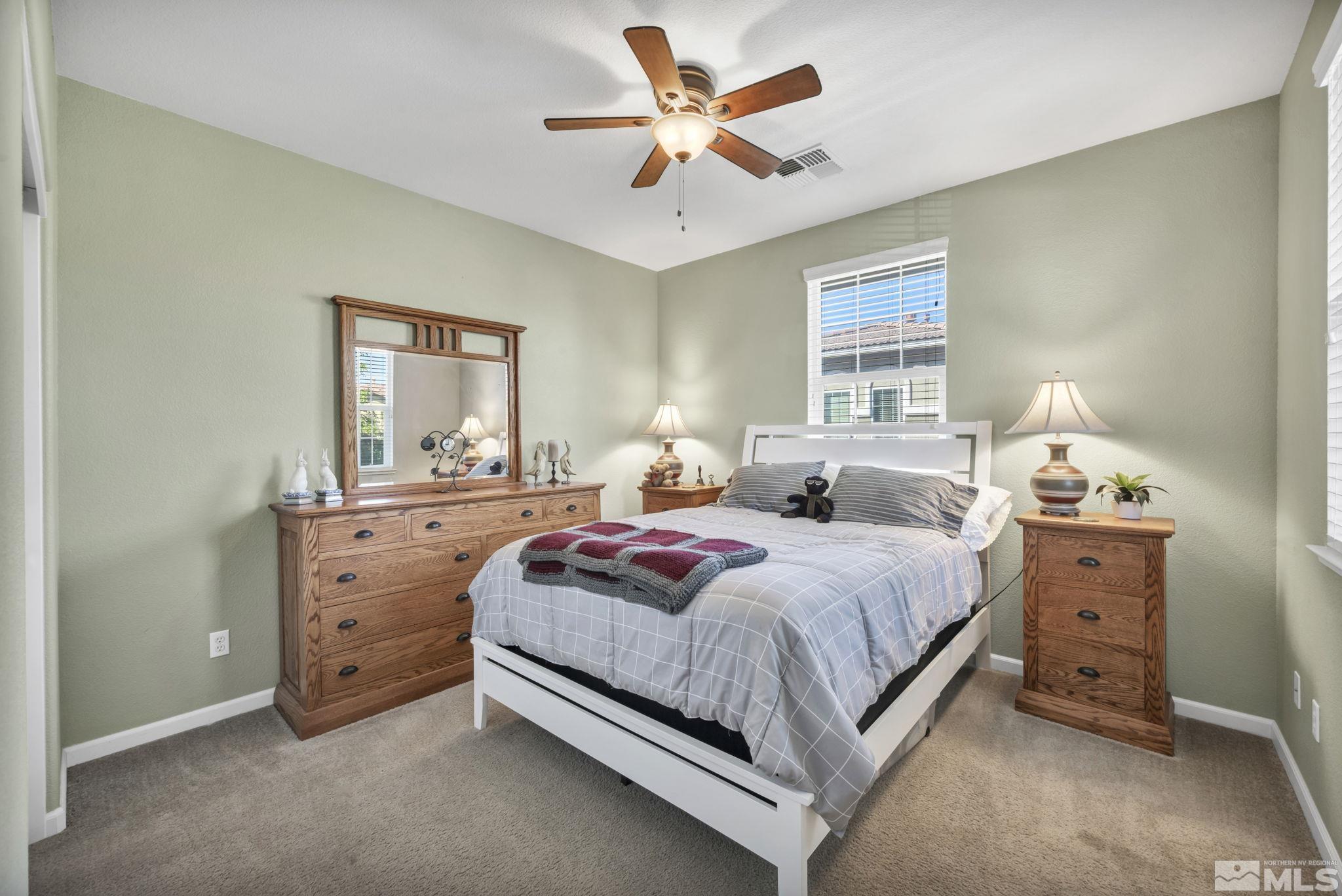 1924 Wind Ranch Road, Unit C Reno, NV 89521 - Photo 24 of 27 a bedroom with a bed and a dresser
