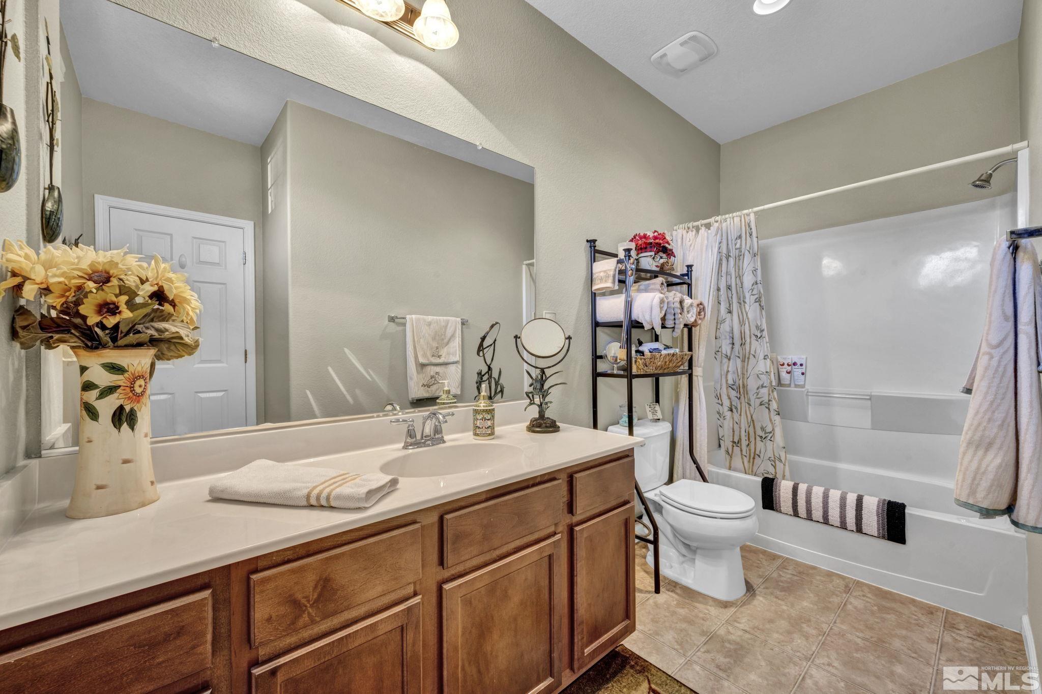 1924 Wind Ranch Road, Unit C Reno, NV 89521 - Photo 26 of 27 a spacious bathroom with a sink toilet and shower
