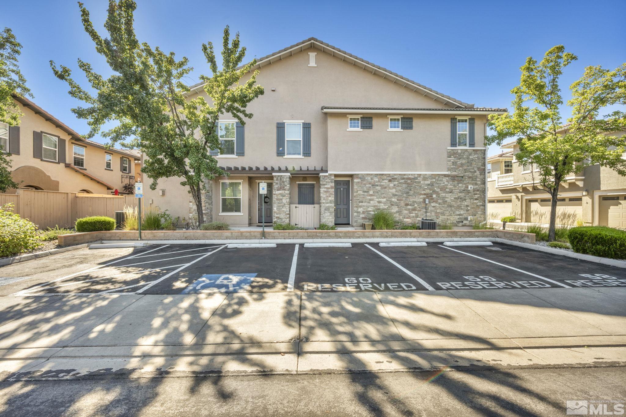 1924 Wind Ranch Road, Unit C Reno, NV 89521 - Photo 3 of 27 a front view of a house with a yard