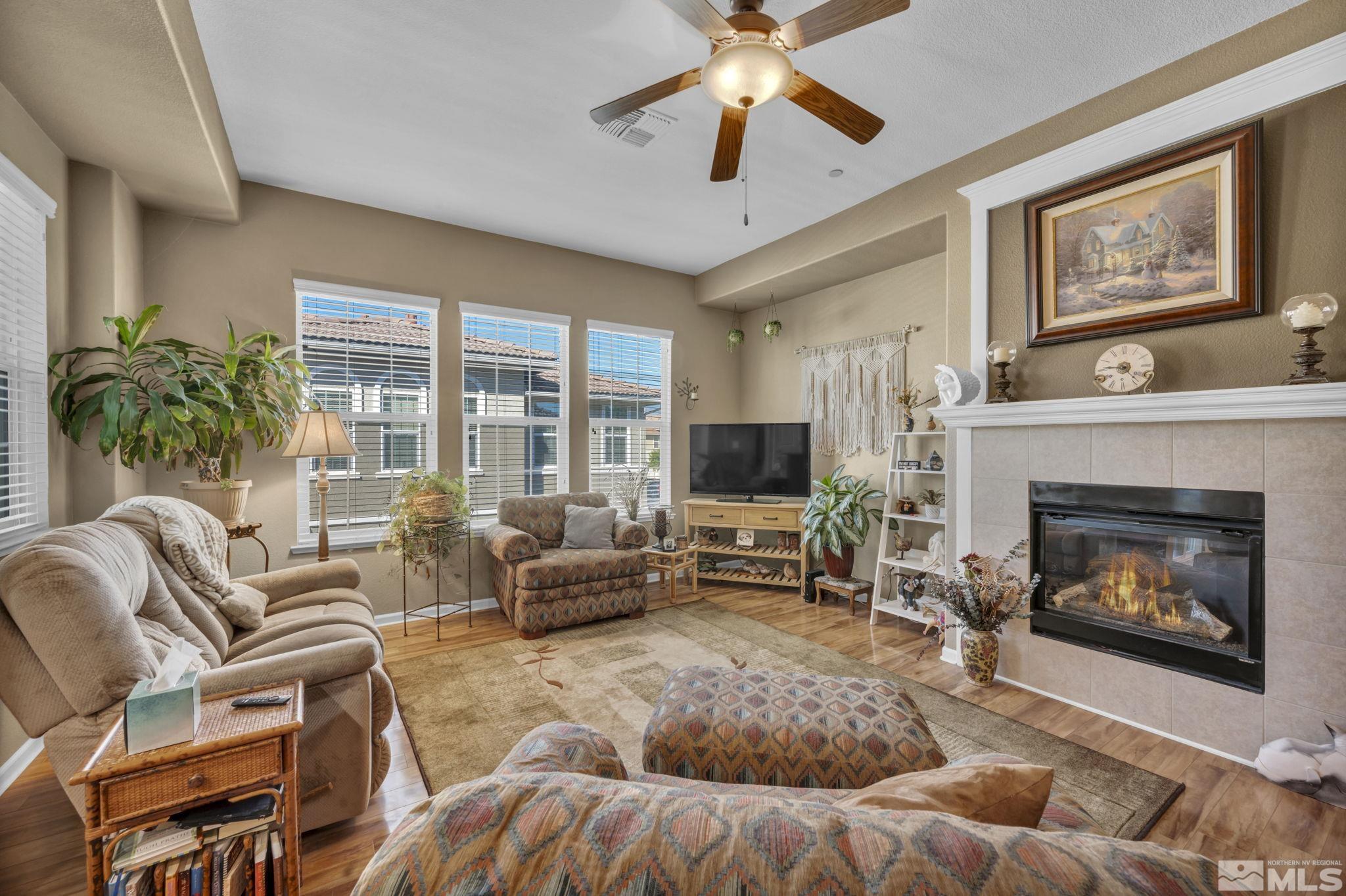 1924 Wind Ranch Road, Unit C Reno, NV 89521 - Photo 9 of 27 a living room with furniture a flat screen tv and a fireplace