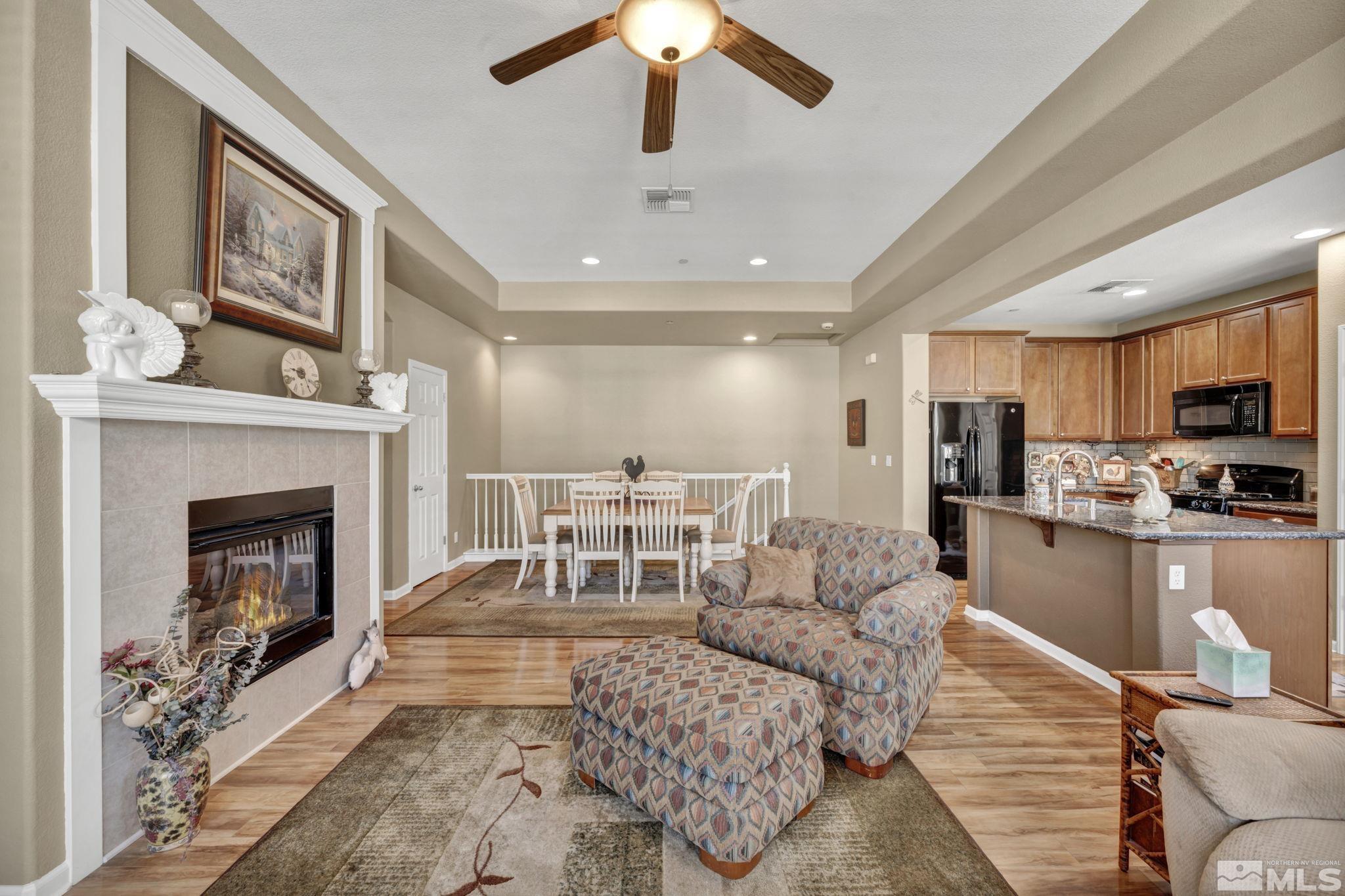 1924 Wind Ranch Road, Unit C Reno, NV 89521 - Photo 10 of 27 a living room with furniture and a fireplace