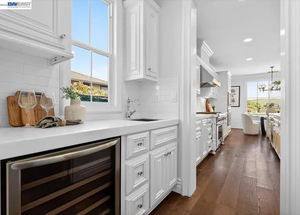 a kitchen with cabinets and wooden floor