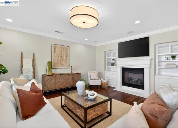 a living room with furniture a fireplace and a flat screen tv