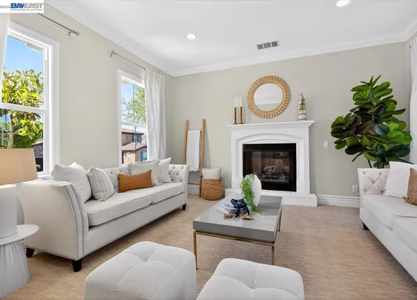 a living room with furniture a fireplace and a window