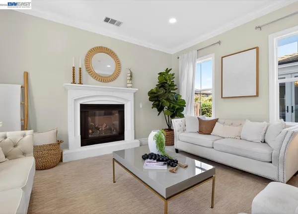 a living room with furniture a rug and a fireplace