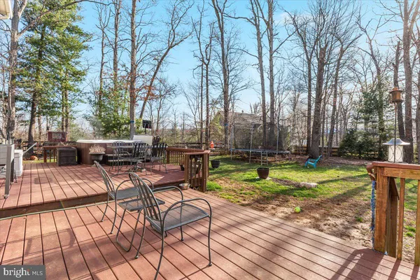 a kitchen with stainless steel appliances kitchen island granite countertop a table and chairs in it