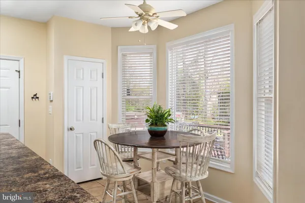 a living room with furniture kitchen view and a window