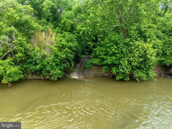 a view of a lush green hillside and a building