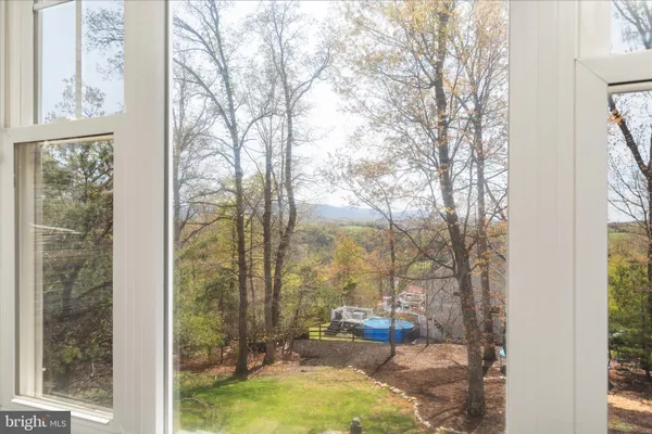 an aerial view of house with yard and mountain view
