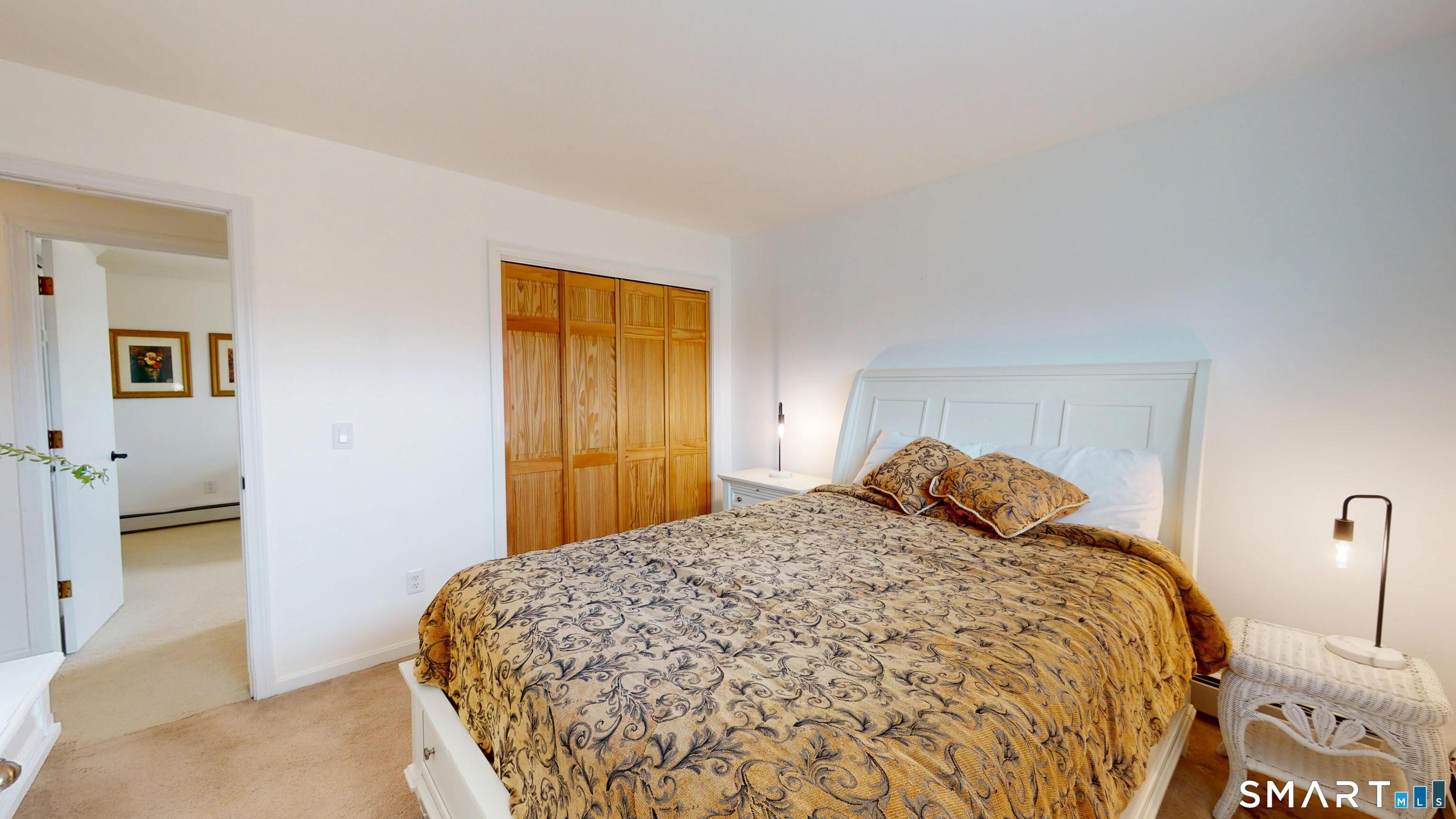 29 Deer Ridge Road Stonington, CT 06378 - Photo 10 of 35 a bedroom with a bed and a cabinets