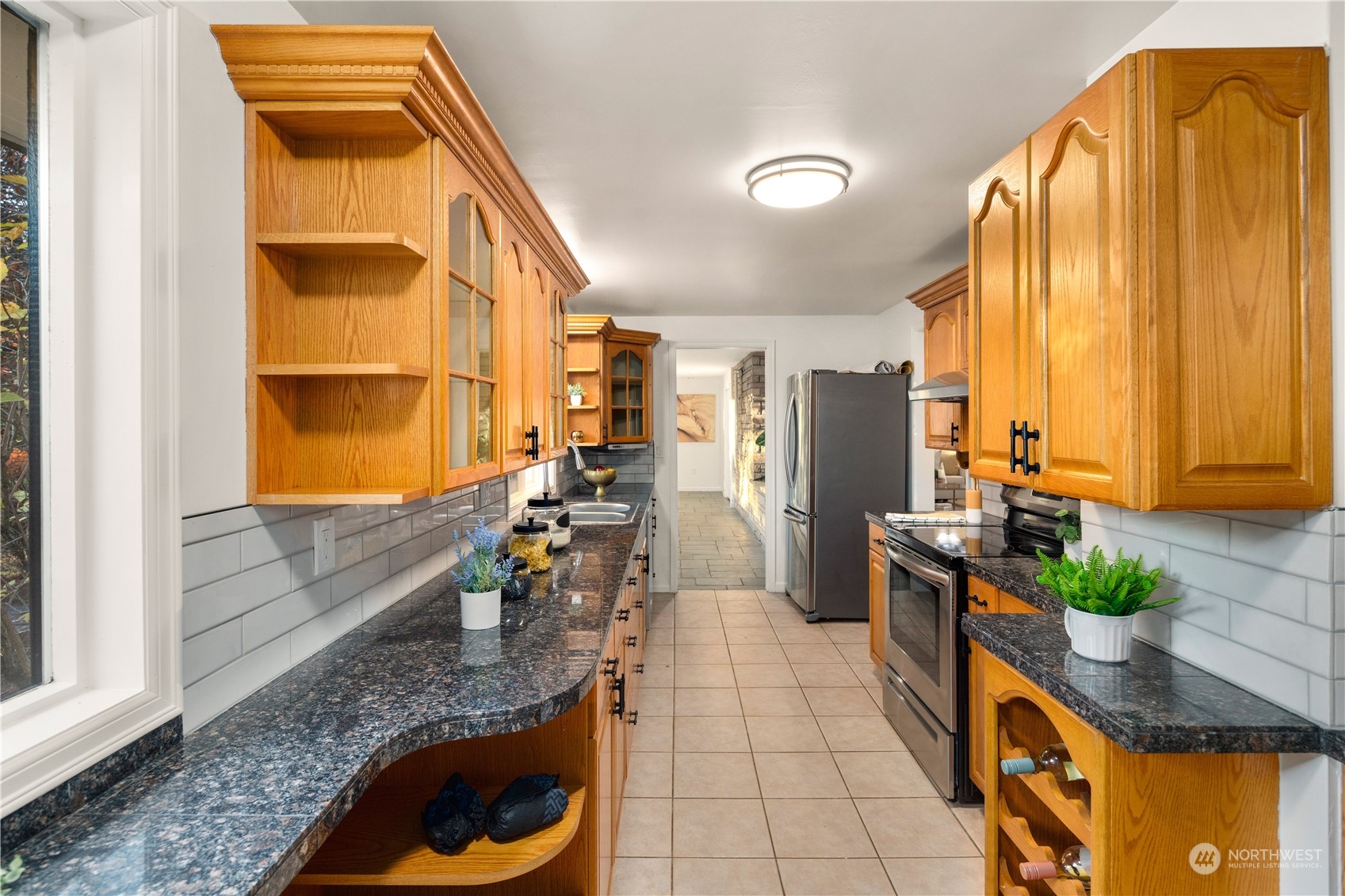 11030 Circle Drive Bothell, WA 98011 - Photo 12 of 38 a kitchen with stainless steel appliances granite countertop sink stove and cabinets