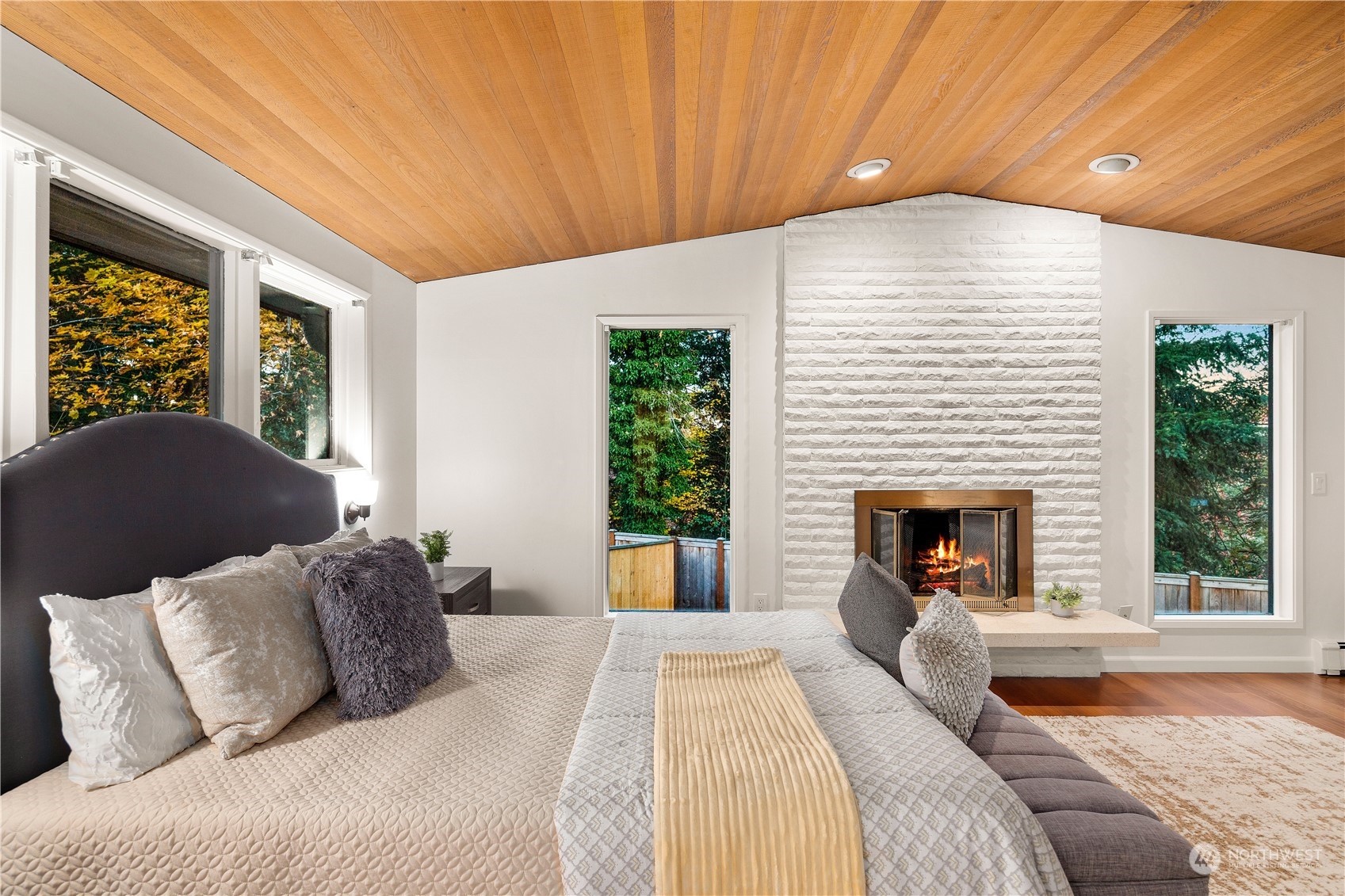 11030 Circle Drive Bothell, WA 98011 - Photo 15 of 38 a bed room with a bed and a fireplace