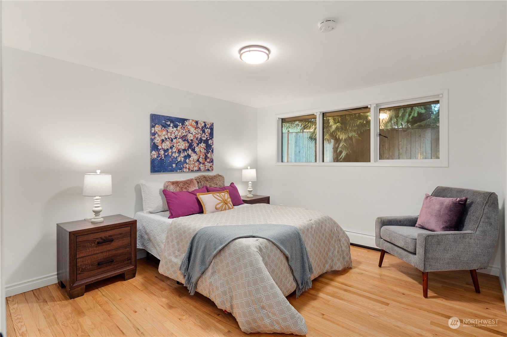 11030 Circle Drive Bothell, WA 98011 - Photo 20 of 38 a bedroom with a bed and wooden floor