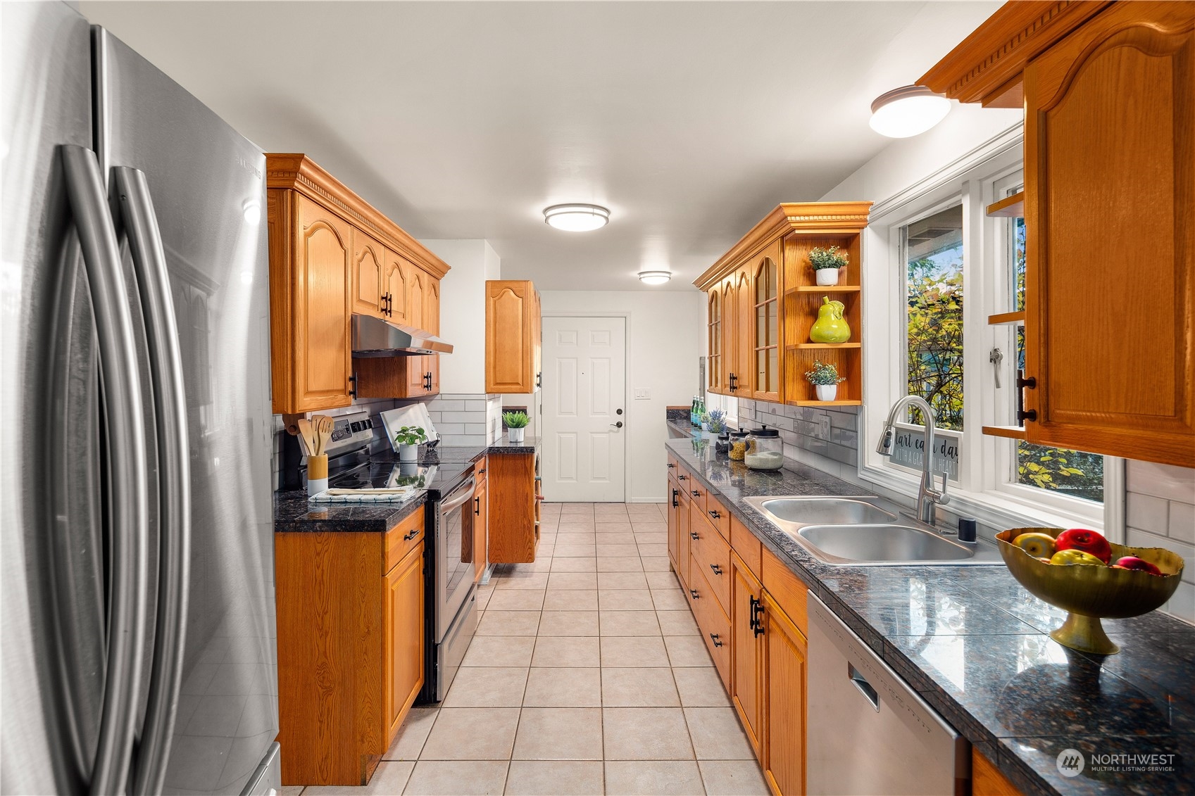 11030 Circle Drive Bothell, WA 98011 - Photo 10 of 38 a large kitchen with stainless steel appliances granite countertop a sink and a refrigerator