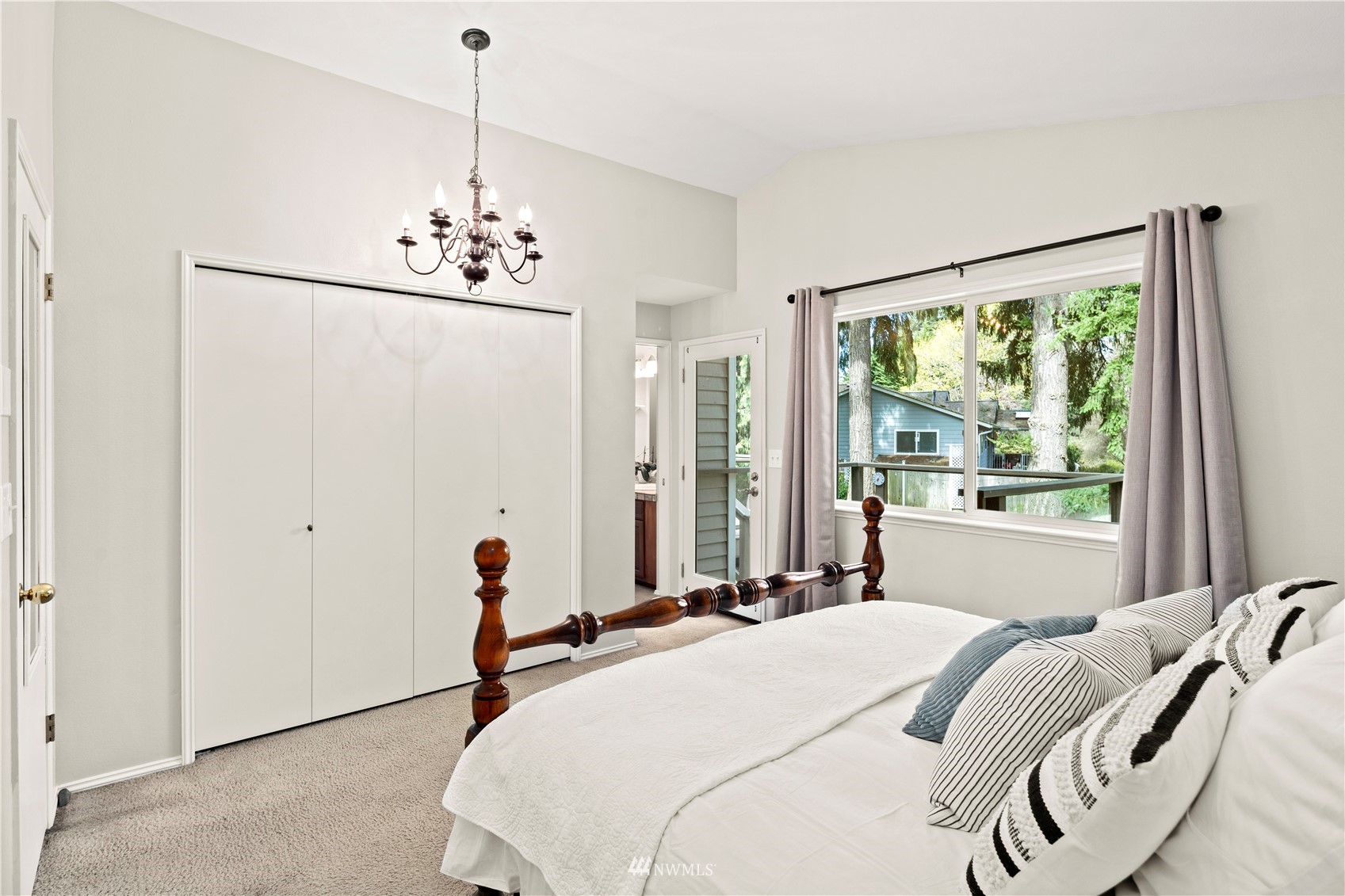 22613 Meridian Avenue South Bothell, WA 98021 - Photo 16 of 39 a bed room with a bed and a chandelier