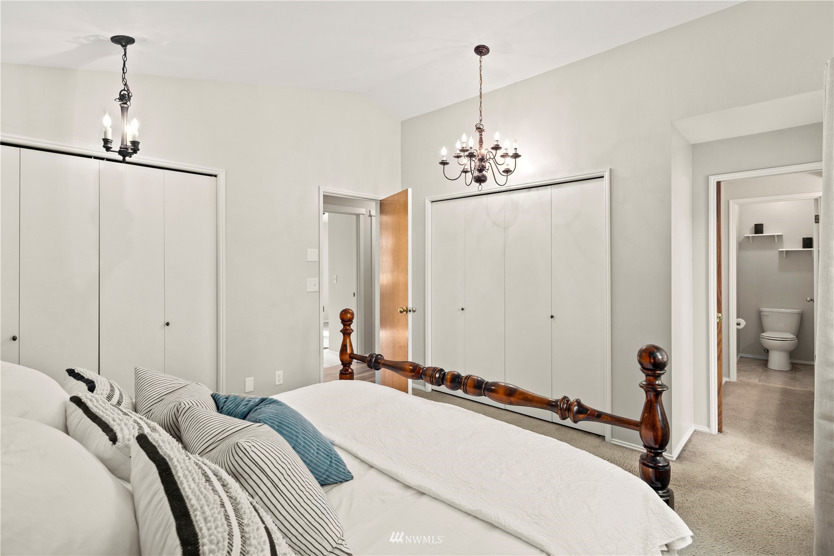 22613 Meridian Avenue South Bothell, WA 98021 - Photo 17 of 39 a bedroom with a bed and a chandelier