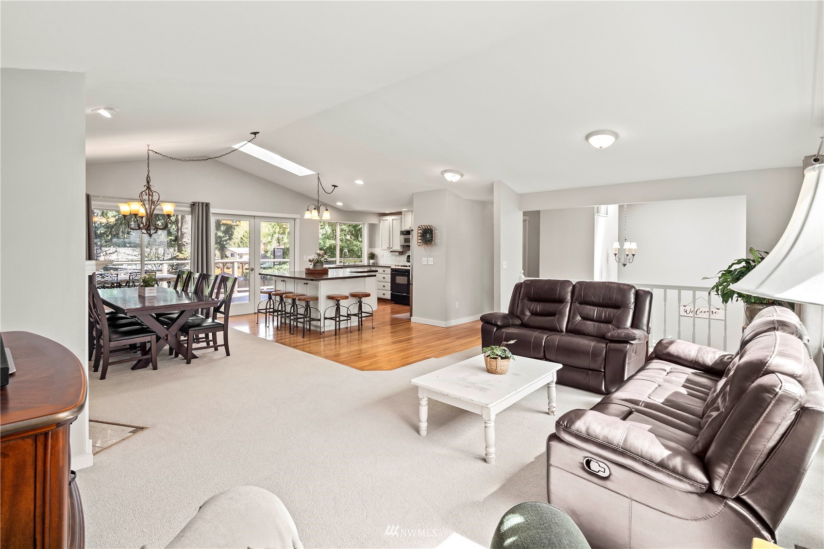 22613 Meridian Avenue South Bothell, WA 98021 - Photo 6 of 39 a living room with furniture and a dining table with kitchen view