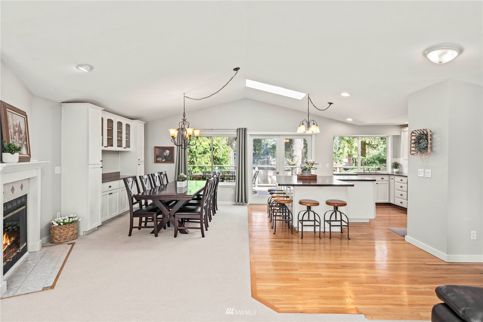 22613 Meridian Avenue South Bothell, WA 98021 - Photo 7 of 39 a dining room with furniture a fireplace and wooden floor