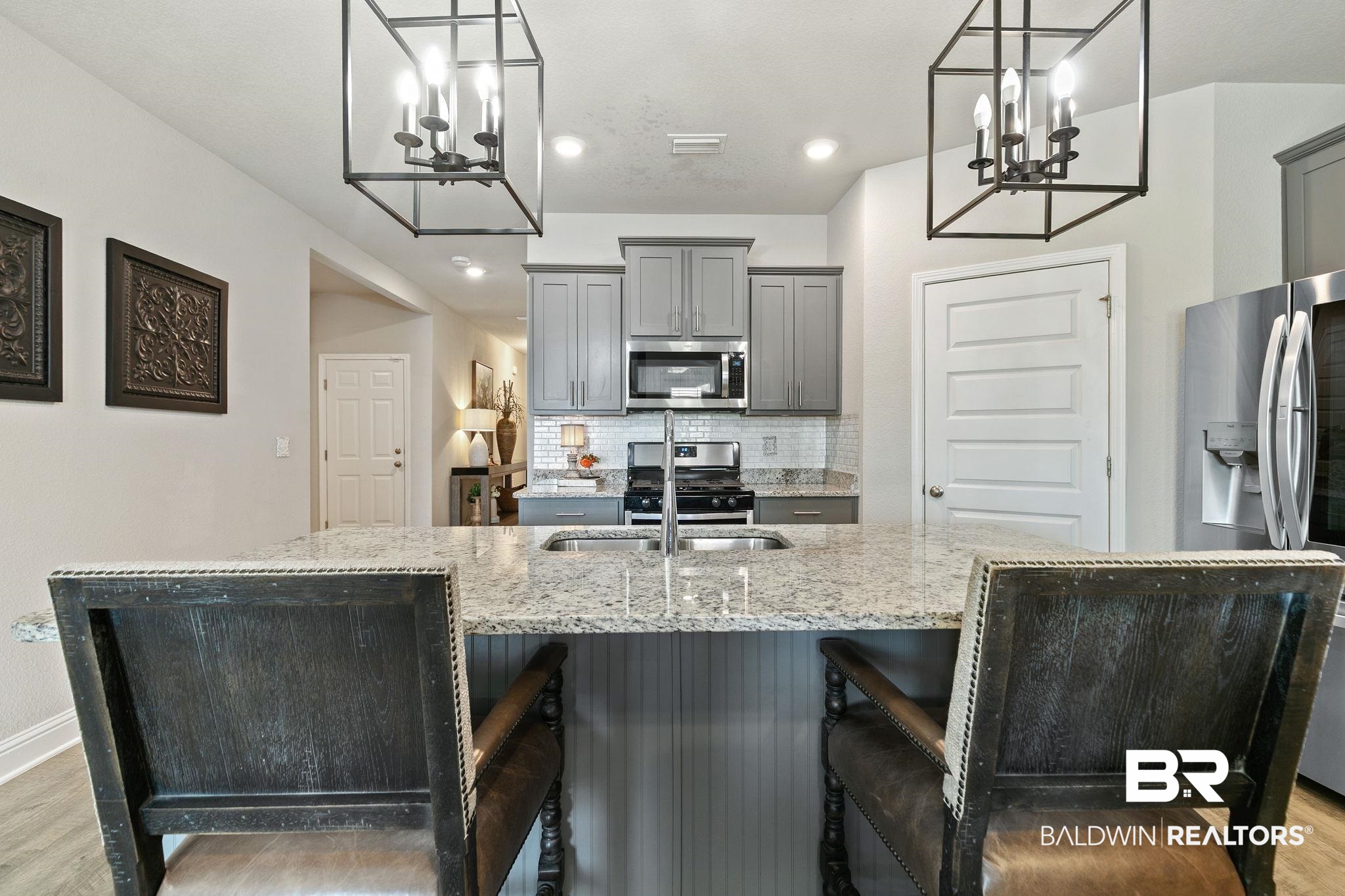 31650 Memphis Loop Daphne, AL 36527 - Photo 10 of 68 Kitchen with gray cabinets, hanging lights, light wood-style floors, and backsplash