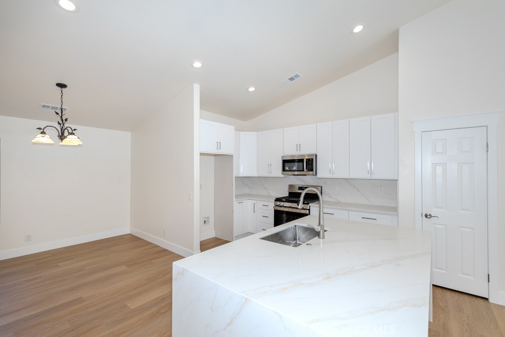 80675 Independence Avenue Indio, CA 92201 - Photo 9 of 72 a kitchen with stainless steel appliances a refrigerator sink and microwave