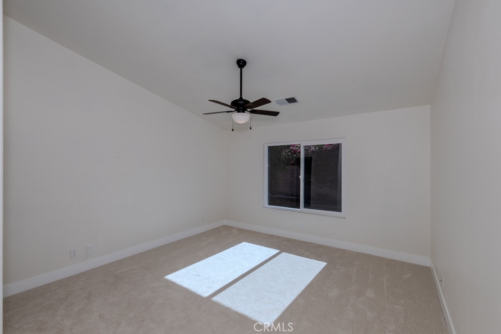 80675 Independence Avenue Indio, CA 92201 - Photo 37 of 72 an empty room with a ceiling fan and a window